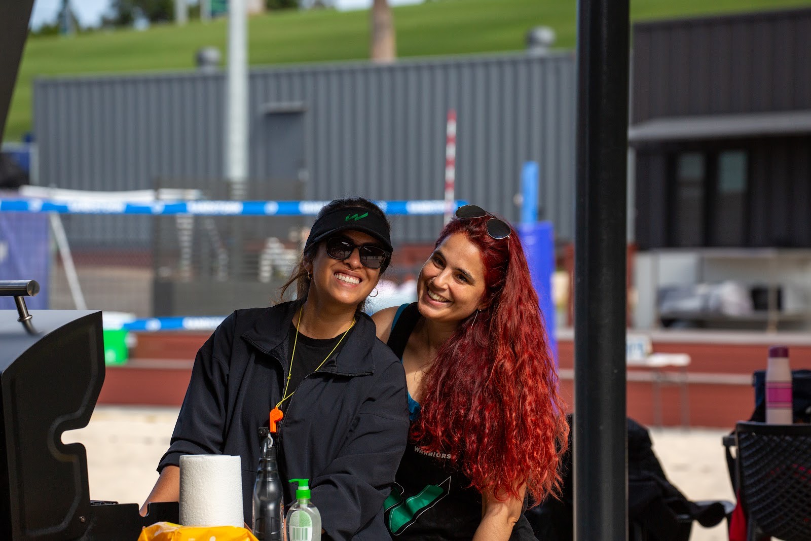 Two volunteers smiling at the barbecue