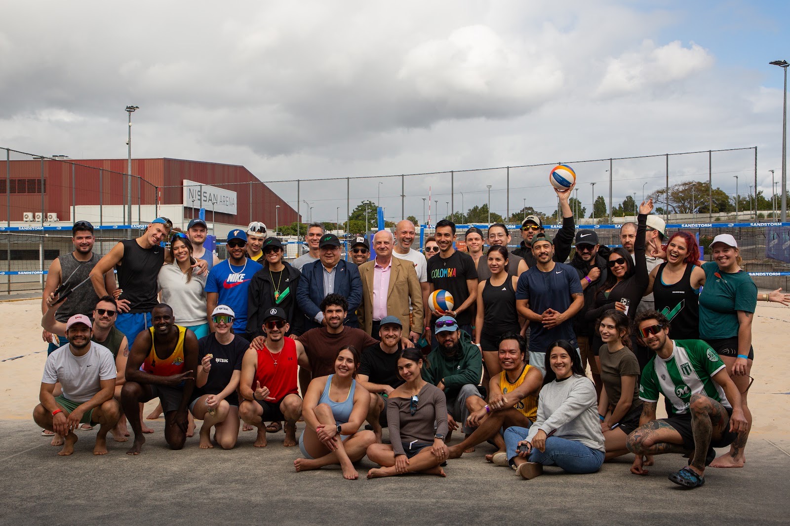 Players, organisers and guests posing together on the sand at Sandstorm Beach Club